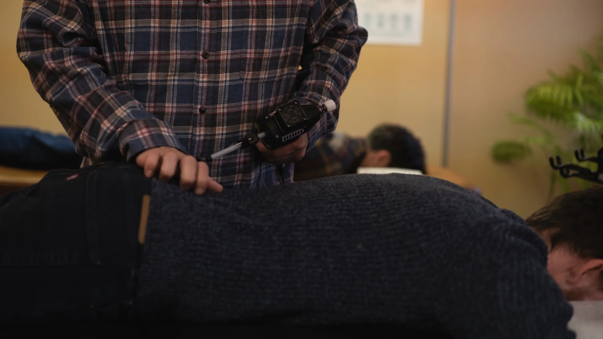 Dr. John using the ArthroStim instrument for Koren Specific Technique chiropractic adjustment